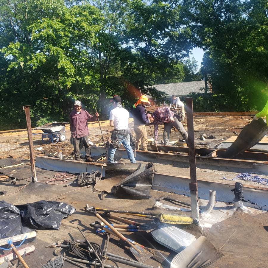 Roofers working on a flat roof