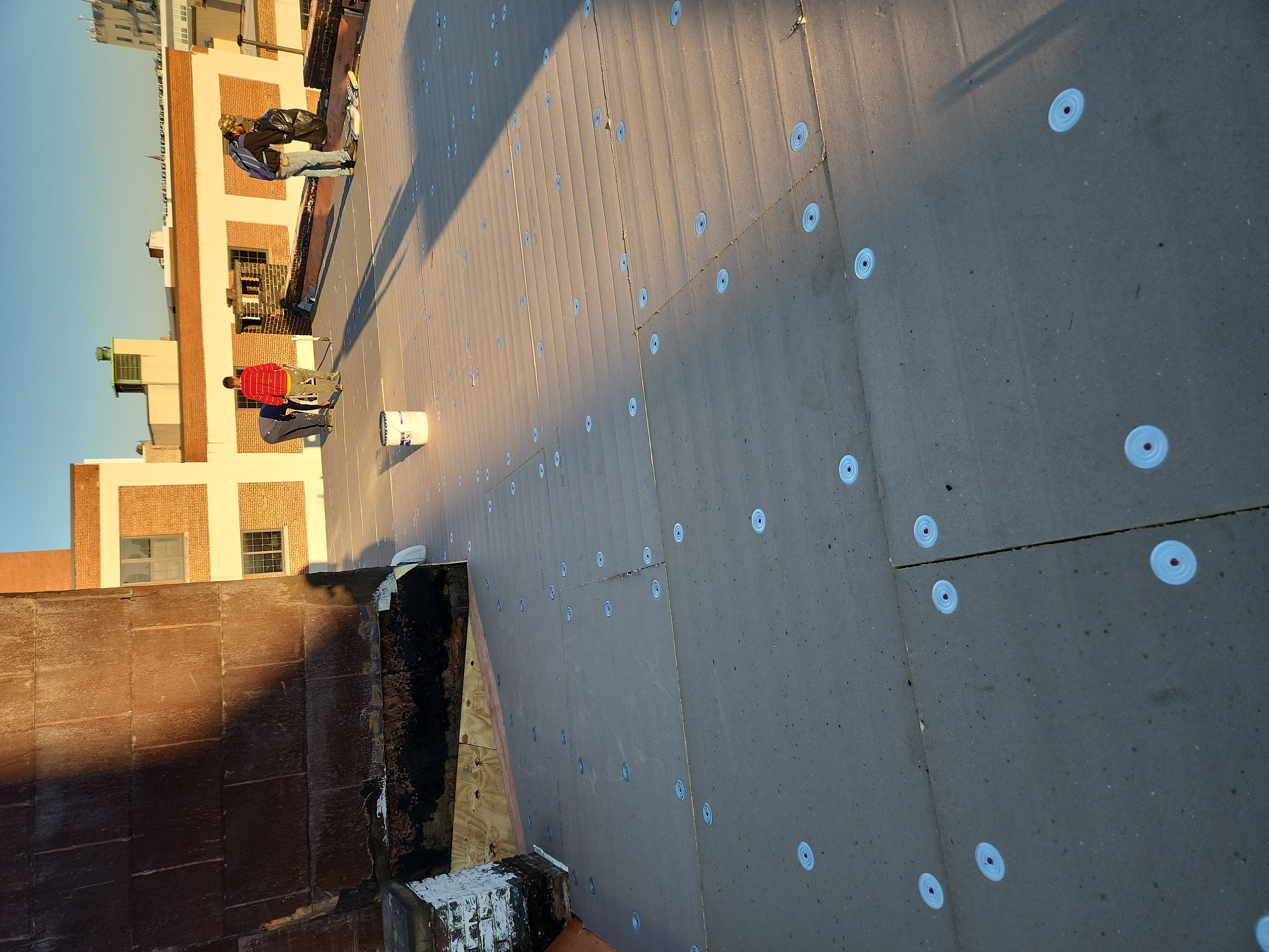 Roofers working on a flat roof