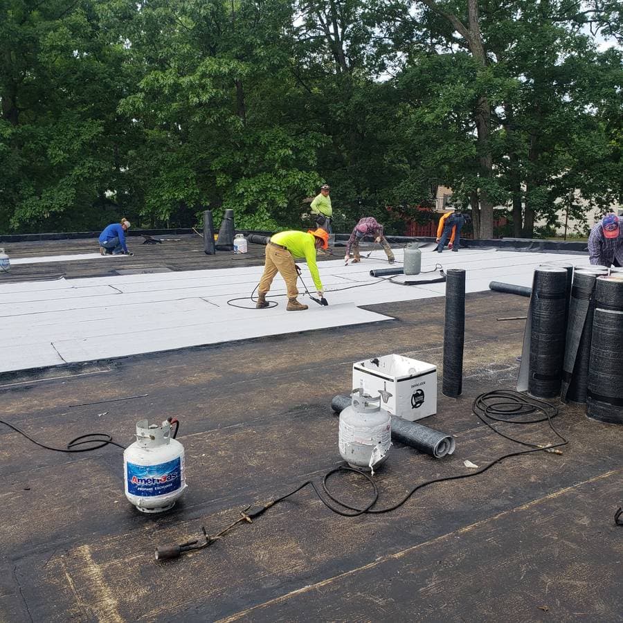 Roofers putting on a new flat roof